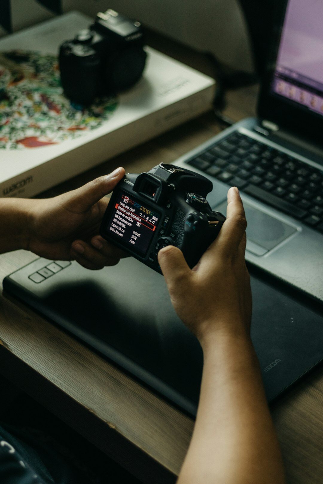 Close up of hands editing a video timeline on a laptop