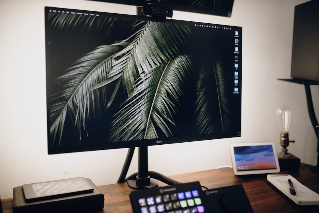 Video editor working on colour grading at a multi-monitor editing suite